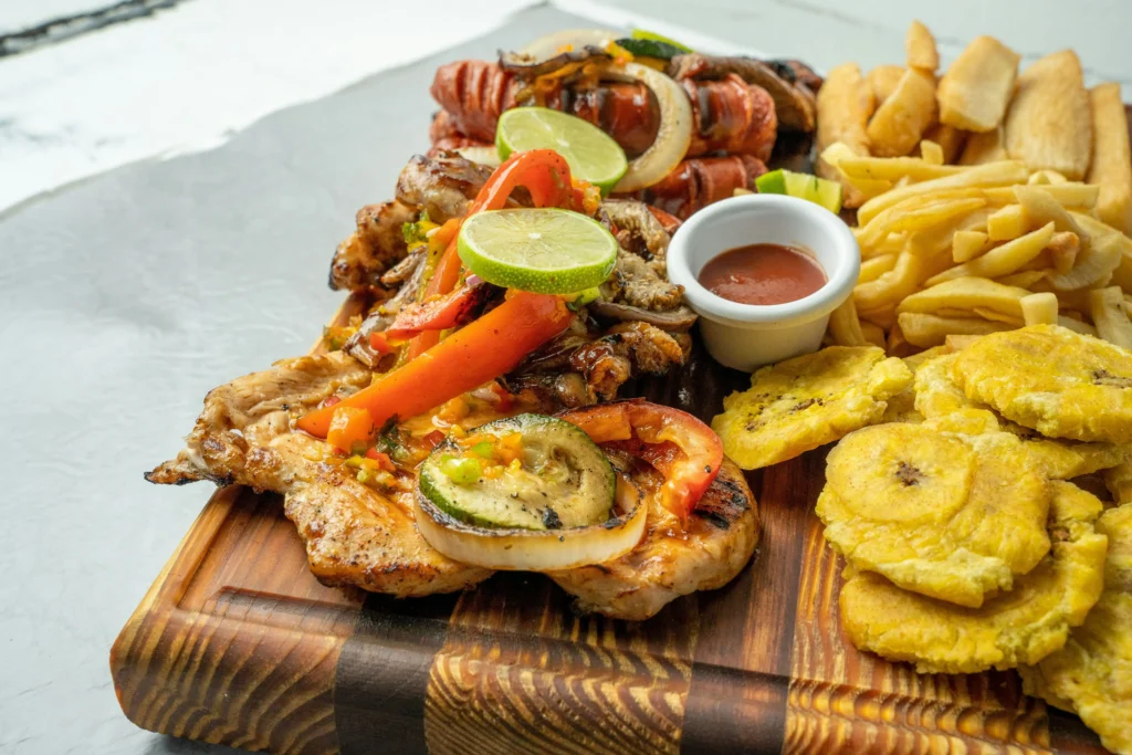 Meat on a wooden plate with fried foods